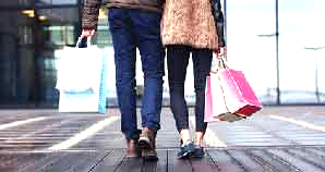Couple walking with shopping bags.